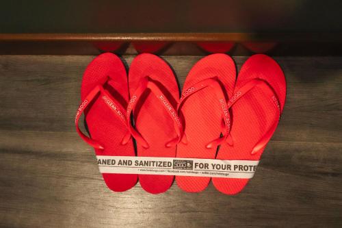 a pair of red shoes with a tape measure on them at Hotel Sogo Dasmariñas Cavite in Dasmariñas