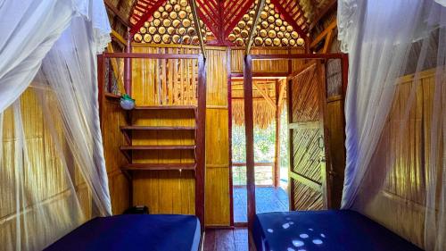 an inside view of a small room with a staircase at Sten Lodge in Labuan Bajo