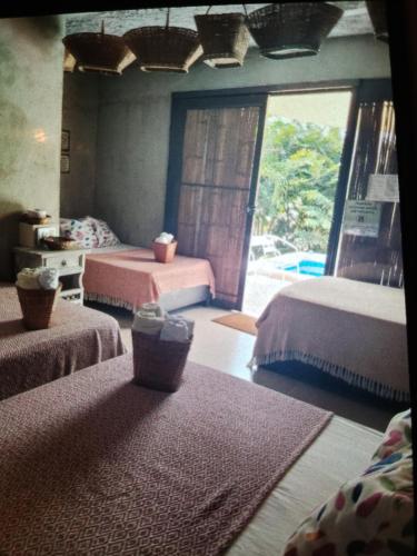 a bedroom with two beds and a large window at EL SHADDAI Punta Del Este Desierto de la Tatacoa in Villavieja