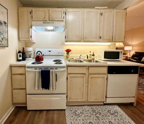 a kitchen with a white stove and a sink at Smoky Hue in Gatlinburg