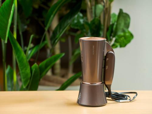 a metal thermos on a table with a plant at Hotel Torifito Naha Asahibashi in Naha
