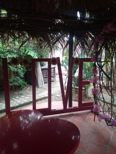 a view of a porch with flowers and a bench at EL SHADDAI Punta Del Este Desierto de la Tatacoa in Villavieja