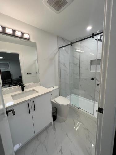 a bathroom with a shower and a toilet and a sink at Calm & Cozy Private Suite in Surrey