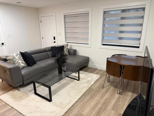 a living room with a couch and a table at Calm & Cozy Private Suite in Surrey