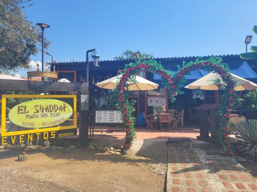 a restaurant with an outdoor patio with an umbrella at EL SHADDAI Punta Del Este Desierto de la Tatacoa in Villavieja