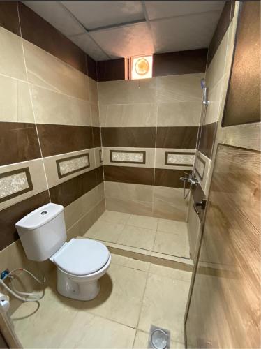 a bathroom with a toilet and a shower at Rum rose luxury camp in Wadi Rum