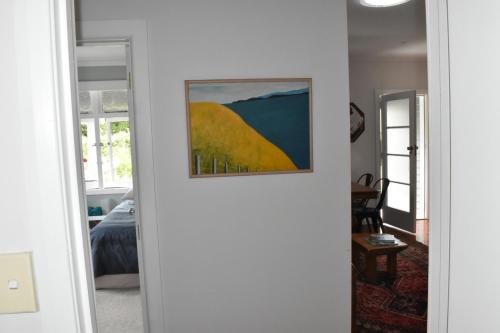 a painting hanging on a wall in a room at Te Hoiere Guesthouse in Havelock