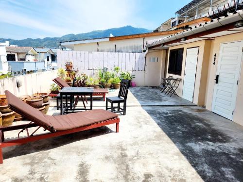 a patio with a table and chairs on a building at SEATEL Phuket, Patong Beach in Patong Beach
