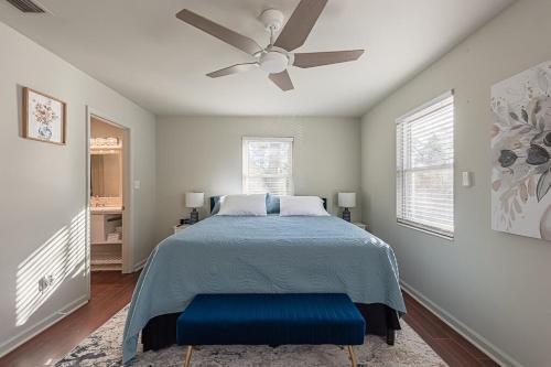 a bedroom with a bed with a ceiling fan at Elegant Townhome Retreat with King Bed Near I-10, Capitol, FSU & FAMU in Tallahassee