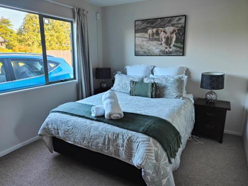 a bedroom with a bed with a blue car out the window at 191 on Main in Methven