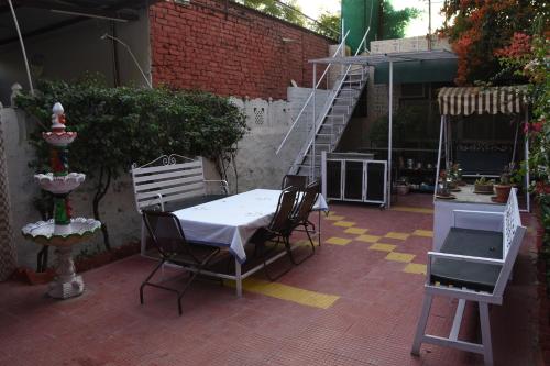 a patio with a table and chairs and a staircase at The Villa- a Home away from Home in Ajmer