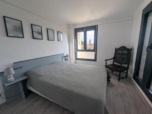 une chambre avec un lit, une chaise et une fenêtre dans l'établissement Maison T4 110m² avec jardin clos, à 1500m de la plage - FR-1-797-60, à Port-la-Nouvelle