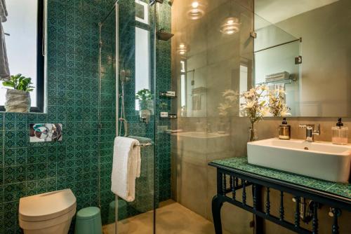 a bathroom with a sink and a shower at Casa, Anjuna villa Vagator, with Pvt pool in Vagator