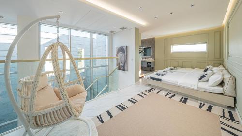 a room with a swing and a bed in it at Eudaimonia Poolvilla Jeju 에다모니아 함덕풀빌라 in Jeju