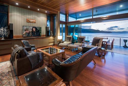 a living room with furniture and a view of the water at Yacht Club 19 - Ocean Front, Pool and 2 buggies in Hamilton Island