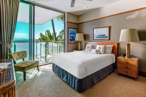 a bedroom with a bed and a balcony at Yacht Club 19 - Ocean Front, Pool and 2 buggies in Hamilton Island