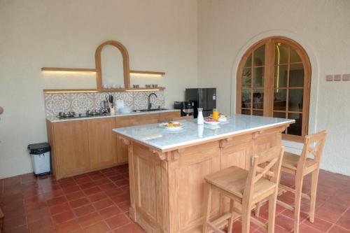 a kitchen with a large island in a room at Princessa by Villa Raminten in Pakem