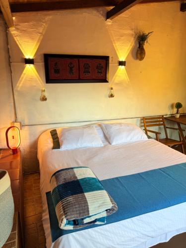 a bedroom with a bed and lights on the wall at Compostela cabaña privada (private cabin for rent) in Jardin