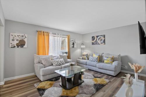a living room with two couches and a table at Luxury 1 bedroom apartment in Cincinnati in Cincinnati