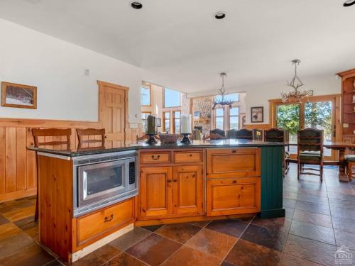 a kitchen with an island with a microwave at Wintertime in Windham