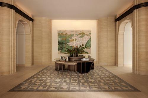 a lobby with a table and a painting on the wall at Capella Taipei in Taipei