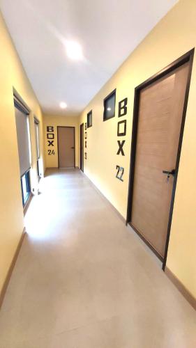 an empty hallway with a door in a building at BOX BOX Hotel and Sports Restaurant in Sattahip