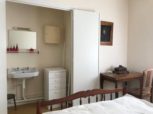 - une chambre avec un lavabo, un miroir et un lit dans l'établissement Villa 2* à Vaux-sur-Mer - Jardin et Animaux admis - FR-1-738-43, à Vaux-sur-Mer