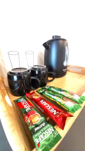 two bags of food sitting on a wooden table at BOX BOX Hotel and Sports Restaurant in Sattahip