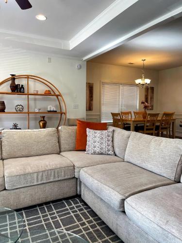 a living room with a couch and a dining room at Walk to GWCC, Mercedes-Benz in Atlanta
