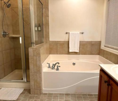 a bathroom with a bath tub and a shower at Walk to GWCC, Mercedes-Benz in Atlanta