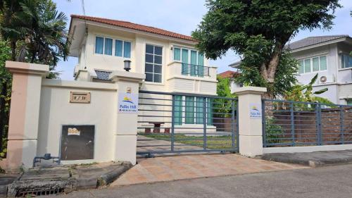 a house with a gate in front of it at Pailin Hill At Casa Ville Watcharapol in Bangkok