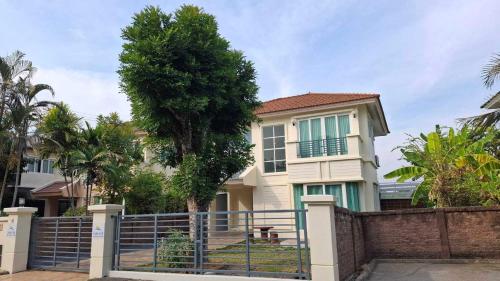 a house with a fence in front of it at Pailin Hill At Casa Ville Watcharapol in Bangkok