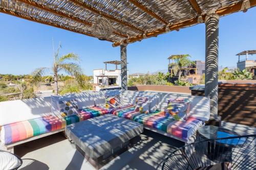 a group of couches sitting on a patio at Ocean and Mountain Views home in El Pescadero in El Pescadero