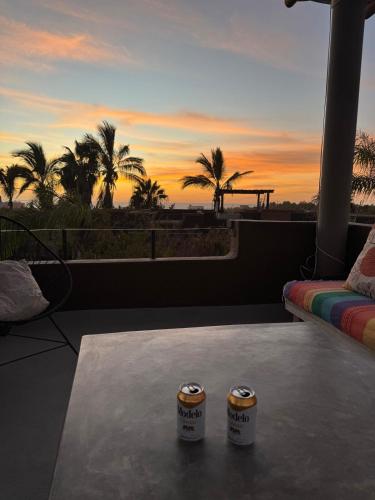 a balcony with a view of the ocean and palm trees at Ocean and Mountain Views home in El Pescadero in El Pescadero