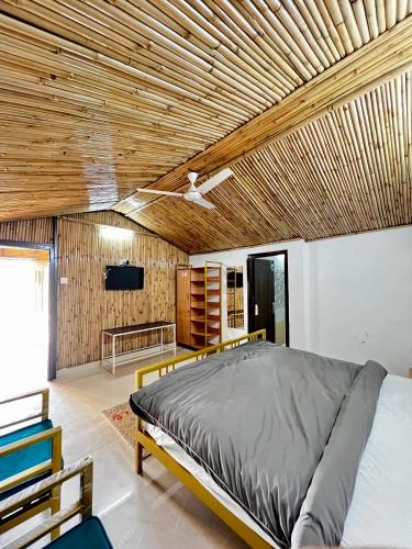 a bedroom with a bed with a wooden ceiling at The Chail Heights Hotel and Resort in Chail
