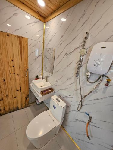 a bathroom with a toilet and a sink at Nhà Bắp in Da Lat