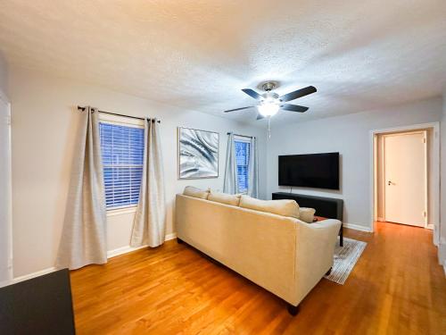 a living room with a couch and a ceiling fan at Peaceful Location Close to University & Hospitals in Lexington