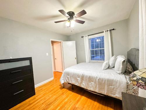 a bedroom with a bed and a ceiling fan at Peaceful Location Close to University & Hospitals in Lexington