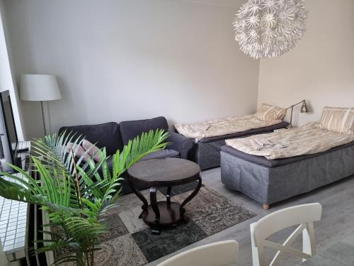 a living room with a couch and a table at Studio Porin Oksi, home away home in Pori city center, free parking in Pori