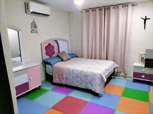 a bedroom with a bed and a colorful rug at central and tourist residence in Ciudad Madero