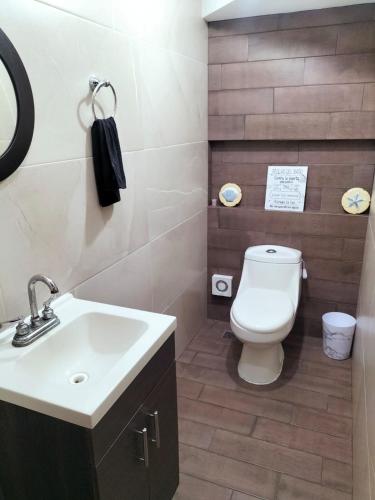 a bathroom with a white sink and a toilet at central and tourist residence in Ciudad Madero