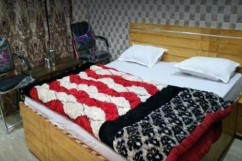 a bed with an american flag blanket on it at Tirath Niwas by StayApart in Kharsālī