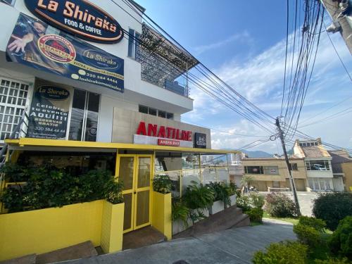 a yellow building with aania sign in front of it at LA CASA DEL CABLE - Hermoso Apartamento - in Manizales