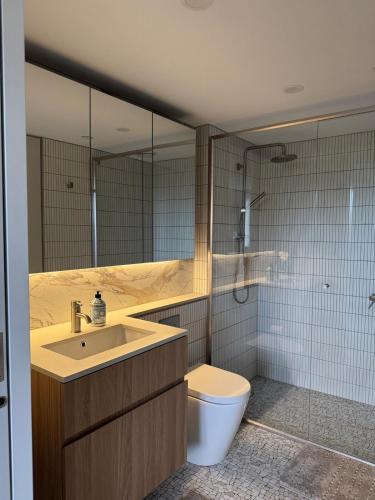 a bathroom with a sink and a toilet at Two Bedroom, Two Bathroom - Kashmir Apartment in Canberra City in Watson
