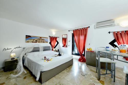 a bedroom with a large bed with red curtains at B&B Vista Gallipoli in Alezio