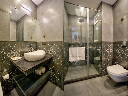a bathroom with a shower and a sink and a toilet at Goa Courtyard by the porto Arpora in Baga