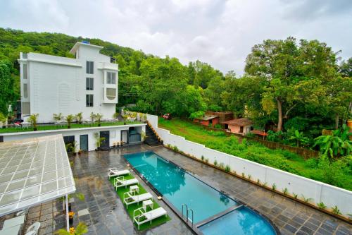 an aerial view of a house with a swimming pool at Goa Courtyard by the porto Arpora in Baga