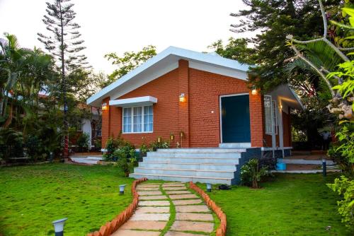 a red brick house with a pathway in front of it at YOLO villa in Pirangut