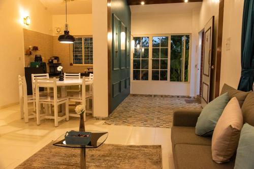 a living room with a couch and a table at YOLO villa in Pirangut