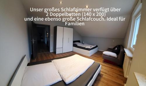 a small room with a bed and a couch at 100 qm DG Wohnung 《Kehr wieder》Bexbach Saarland in Bexbach